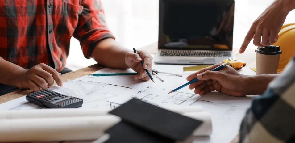 consulting-architect-and-engineer-to-discuss-work-pointing-to-house-plans-to-make-changes